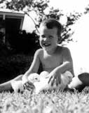 Scott in 1954 with our poodle puppies and on horseback