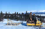 Snowmobiling near Nondalton, view toward Six-Mile Lake, J. Chambers and Nurse M. Jensen March 1972